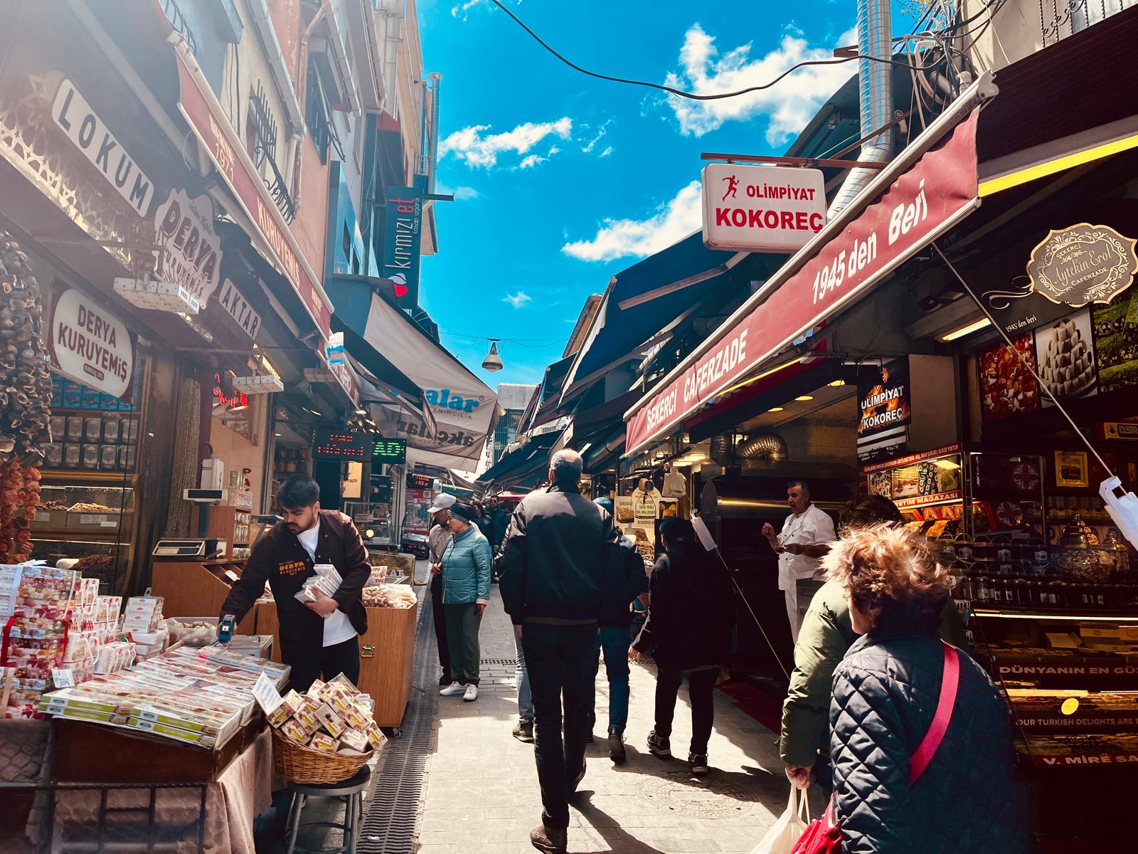 Shoppers walking through a vibrant food street in Kadıköy
