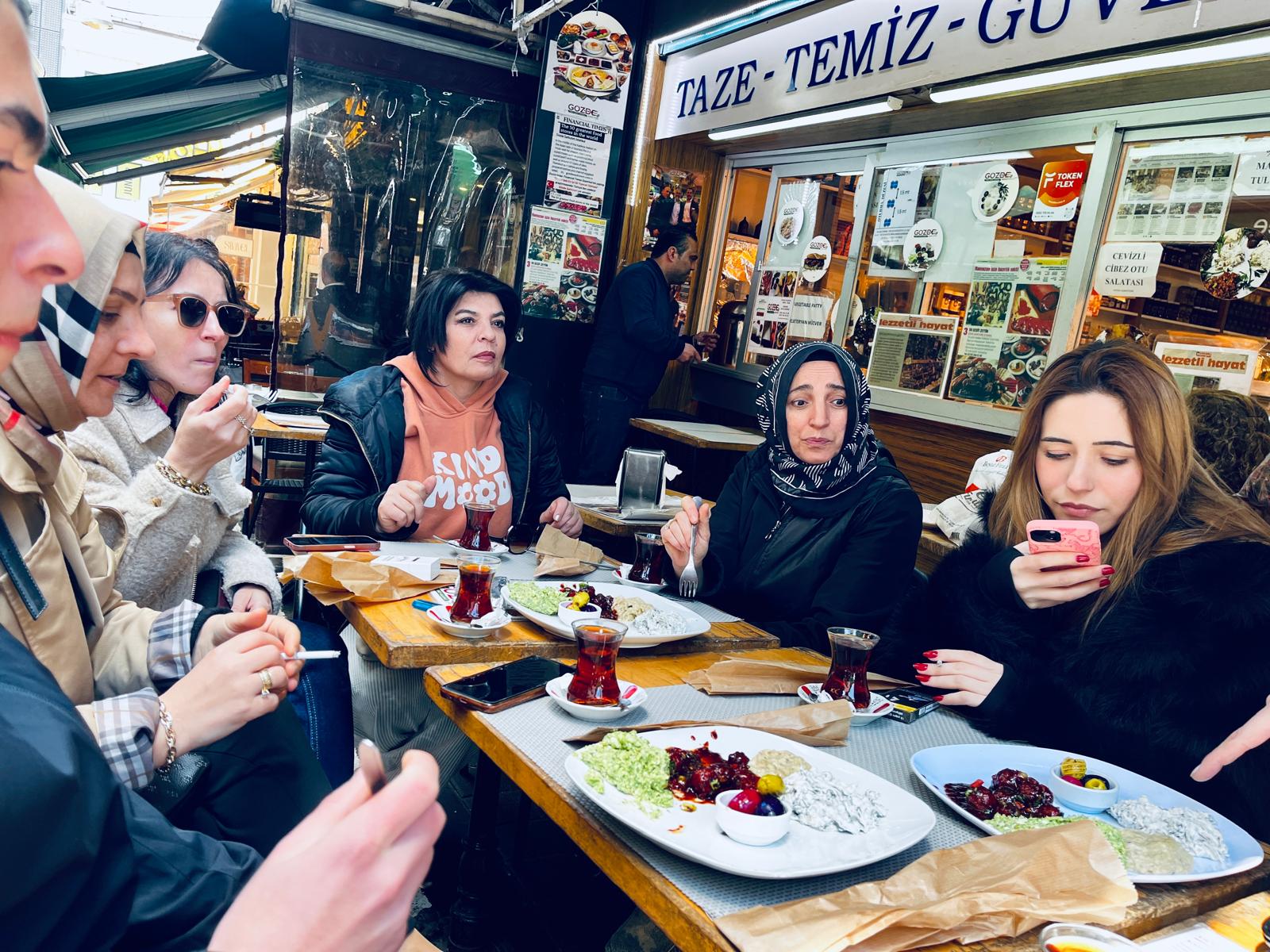 Locals and visitors enjoying a meal at a cozy eatery in Kadıköy